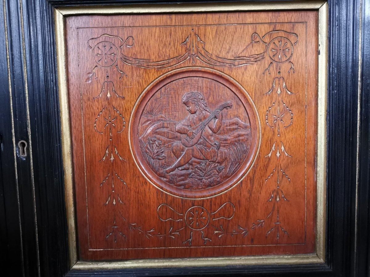Aesthetic Movement Side Cabinet With Carved Panels Of Putti Putti Playing Music. photo vintage