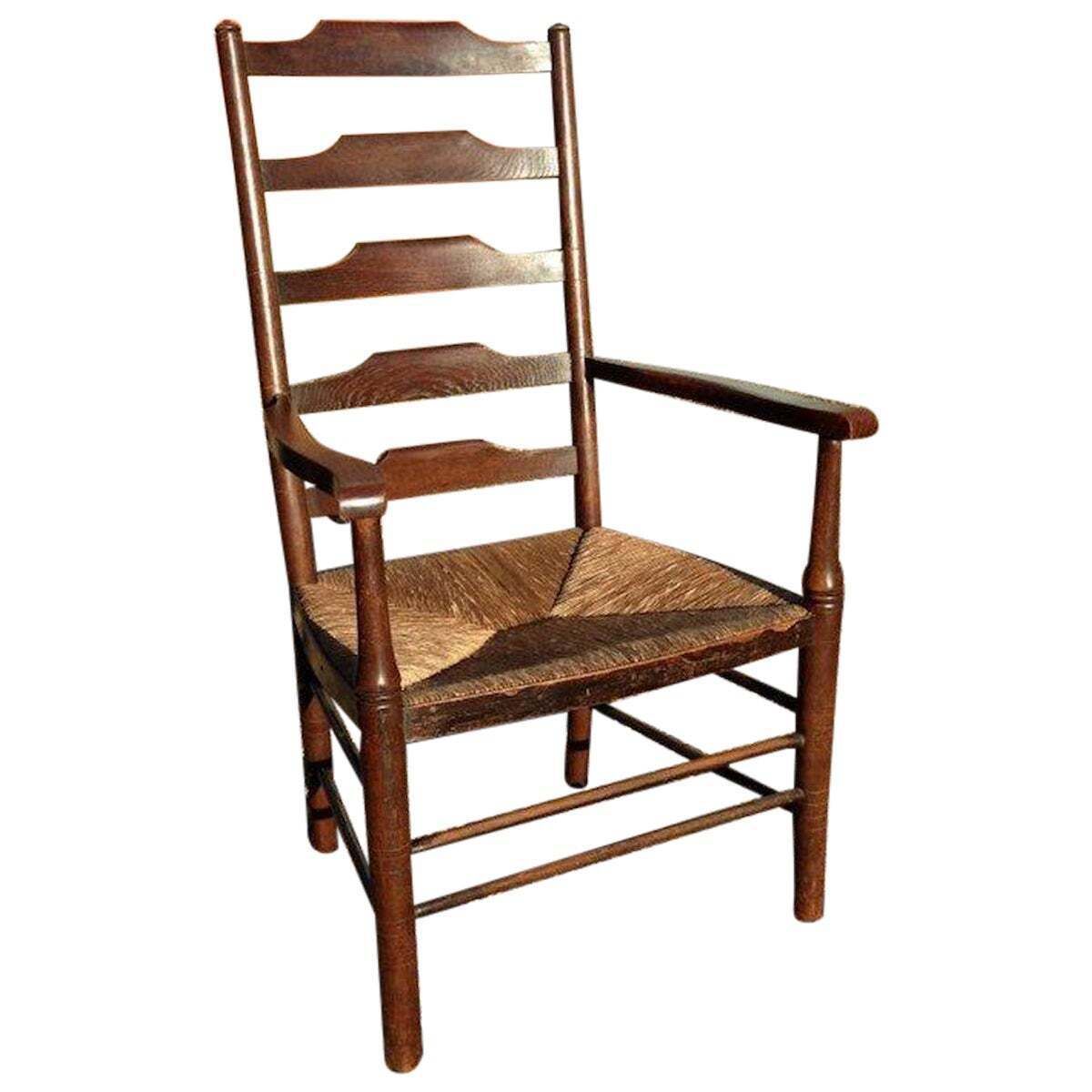 An English Cotswold School Oak Ladder Back Rush Seat Armchair