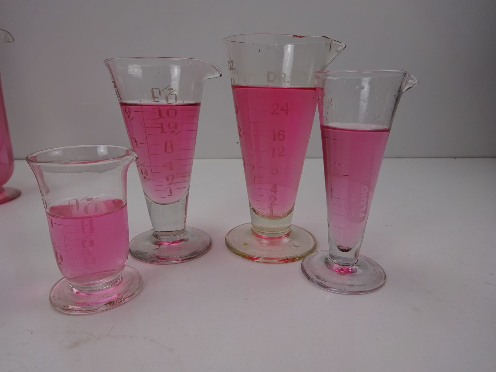 160.0 8 Early 1900s Chemist Measuring Glasses & 2 Stirrers photo