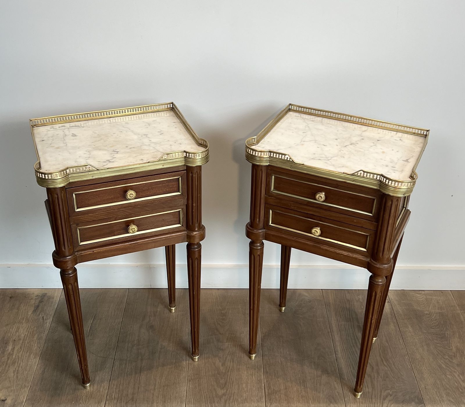 Furniture Pair Of Mahogany And Brass End Tables Or Bedside Tables With Carrara Marble Tops In The Style Of Maison Jansen. Circa 1940 photo