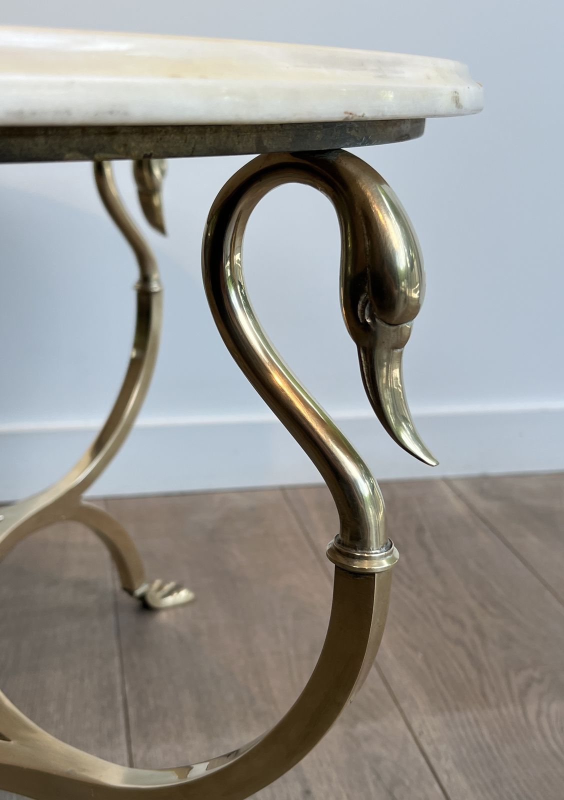 photo furniture Neoclassical Style Round Brass Coffee Table With Swan Necks And Legs And Brass Inlaid Marble Top From Maison Jansen