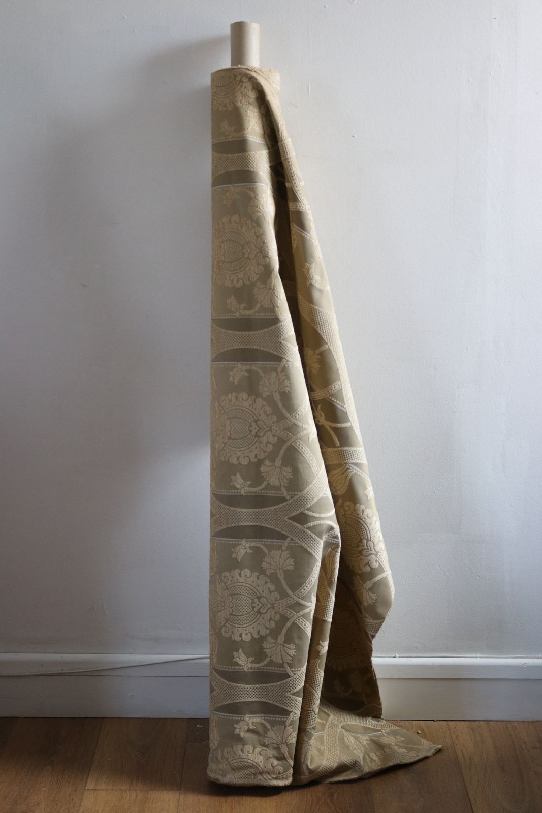 Roll Of Gold Fabric With A Decorative Design photo furniture
