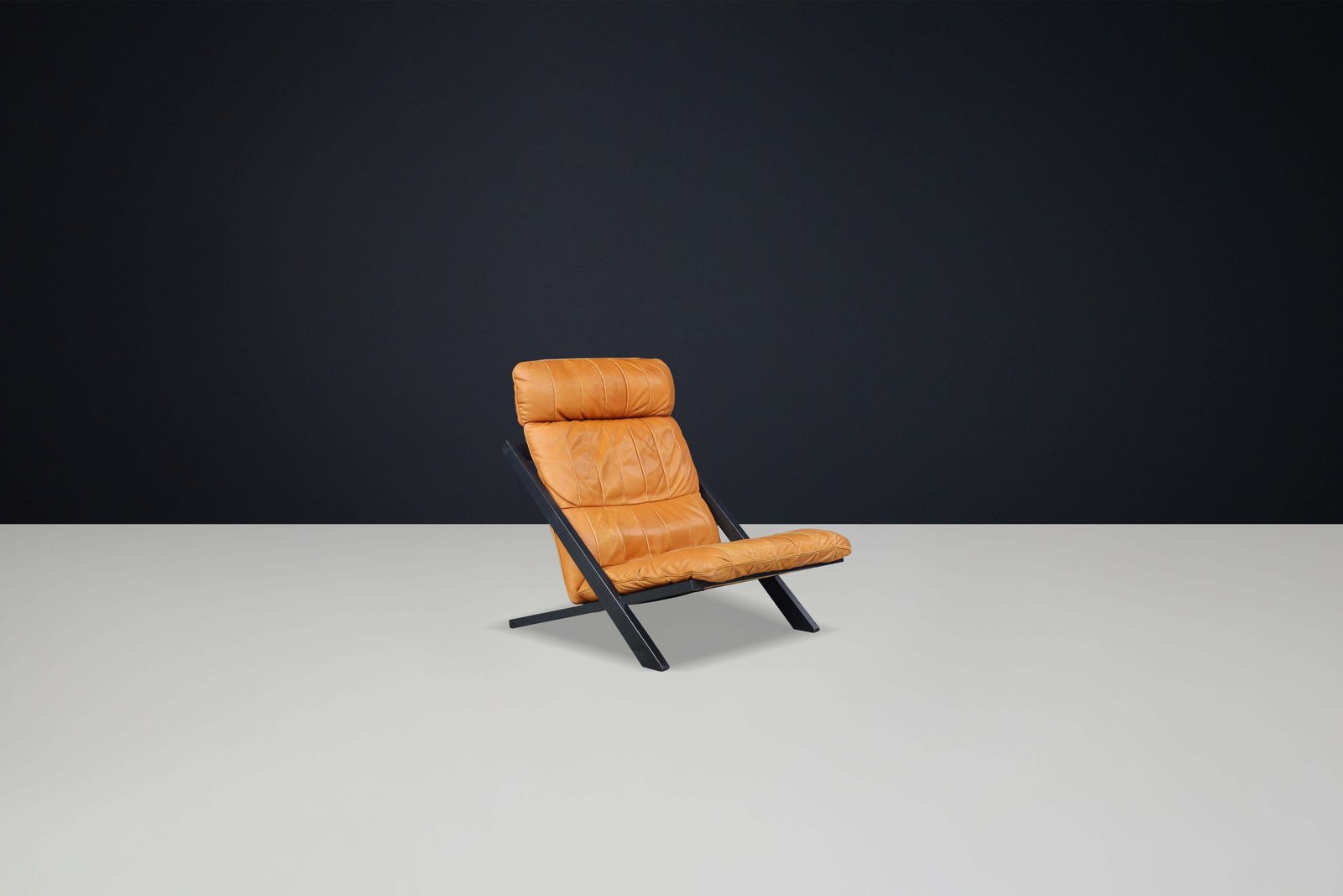 photo furniture Ueli Berger For De Sede, Lounge Chair, Wood, Cognac Leather, Switzerland, 1970s.