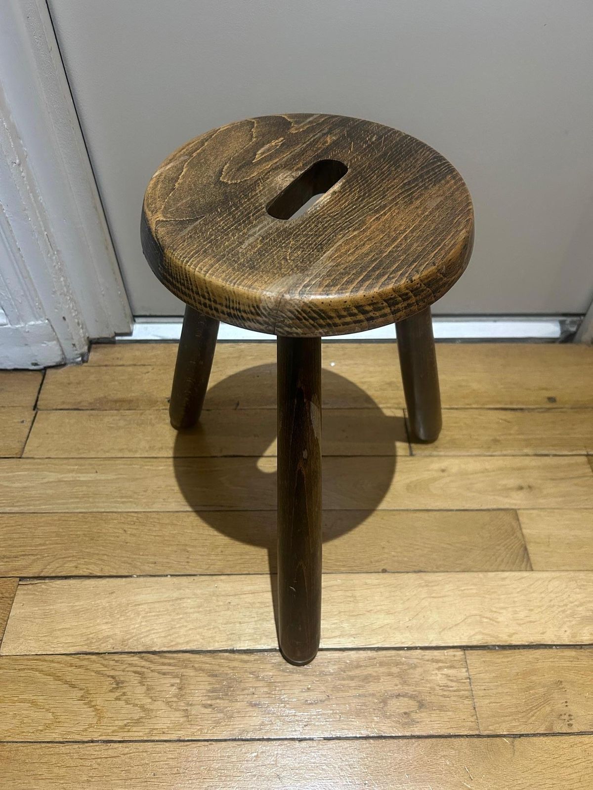 A Three Legged Wooden Stool With A Strong Brutalist photo furniture