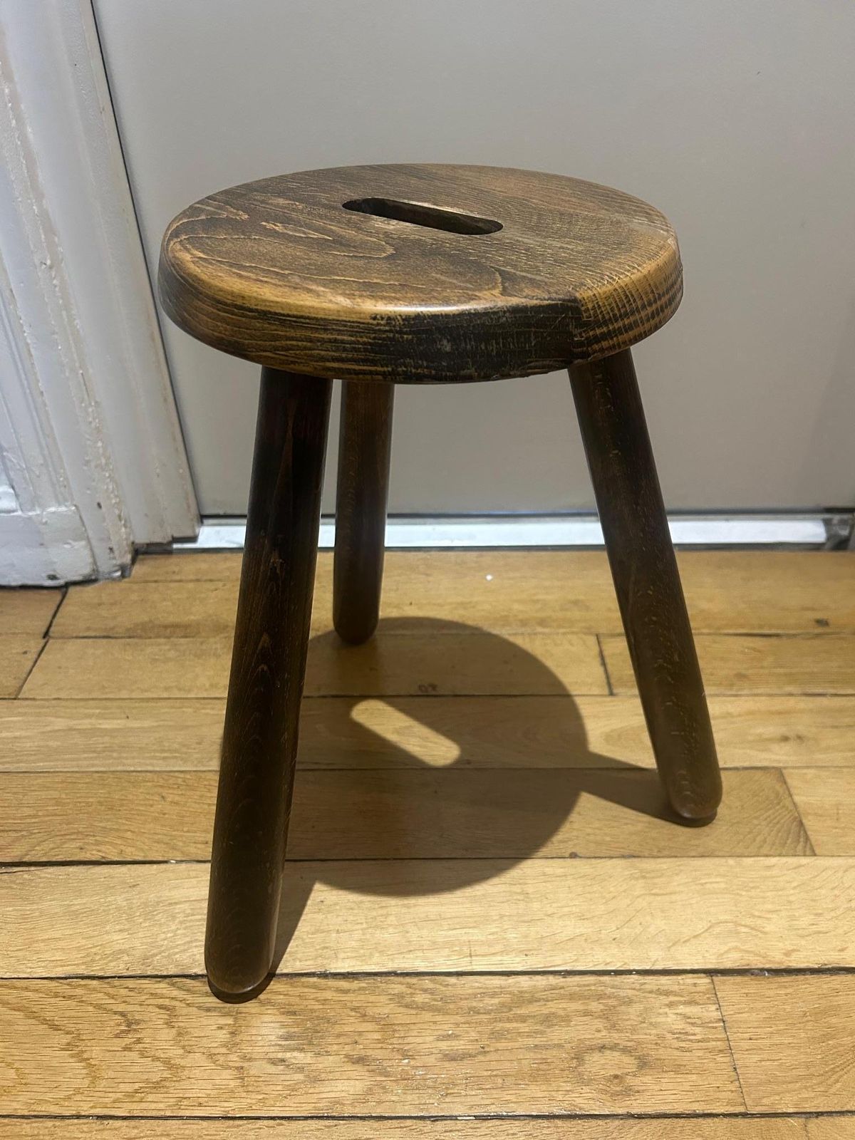 A Three Legged Wooden Stool With A Strong Brutalist photo Furniture