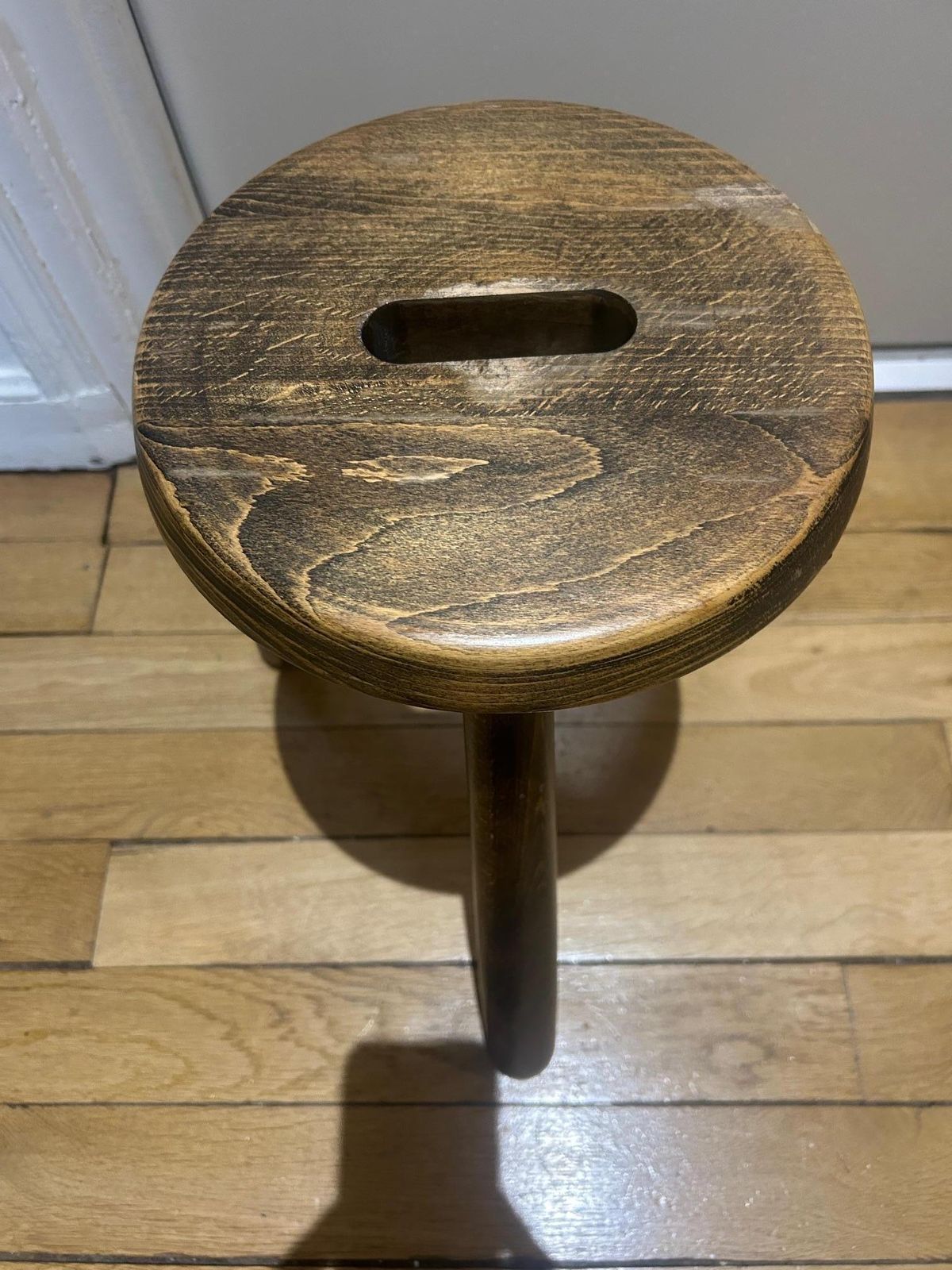 A Three Legged Wooden Stool With A Strong Brutalist photo vinterior