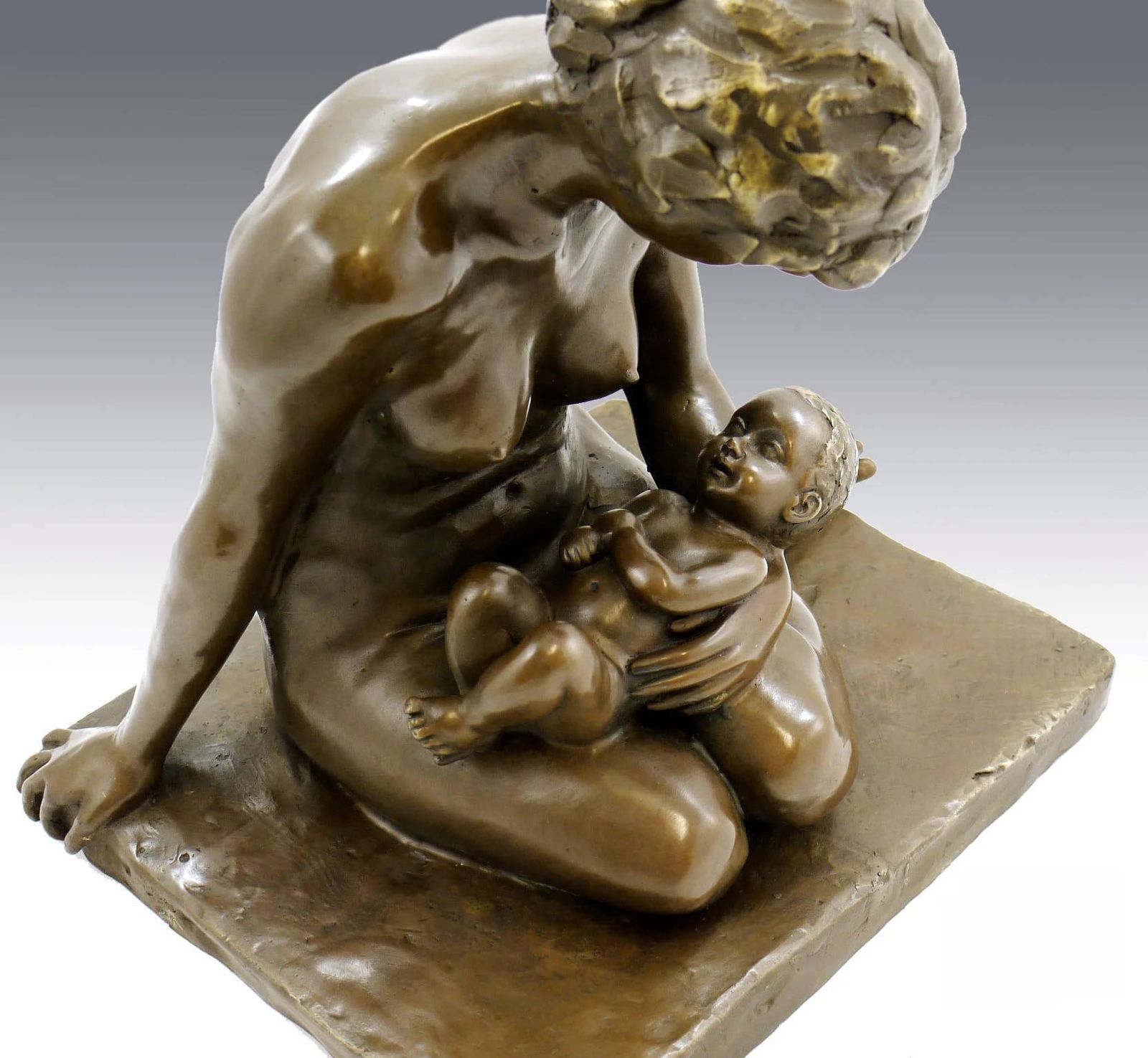 Bronze Sculpture Depicting A Mother And Her Child photo Art