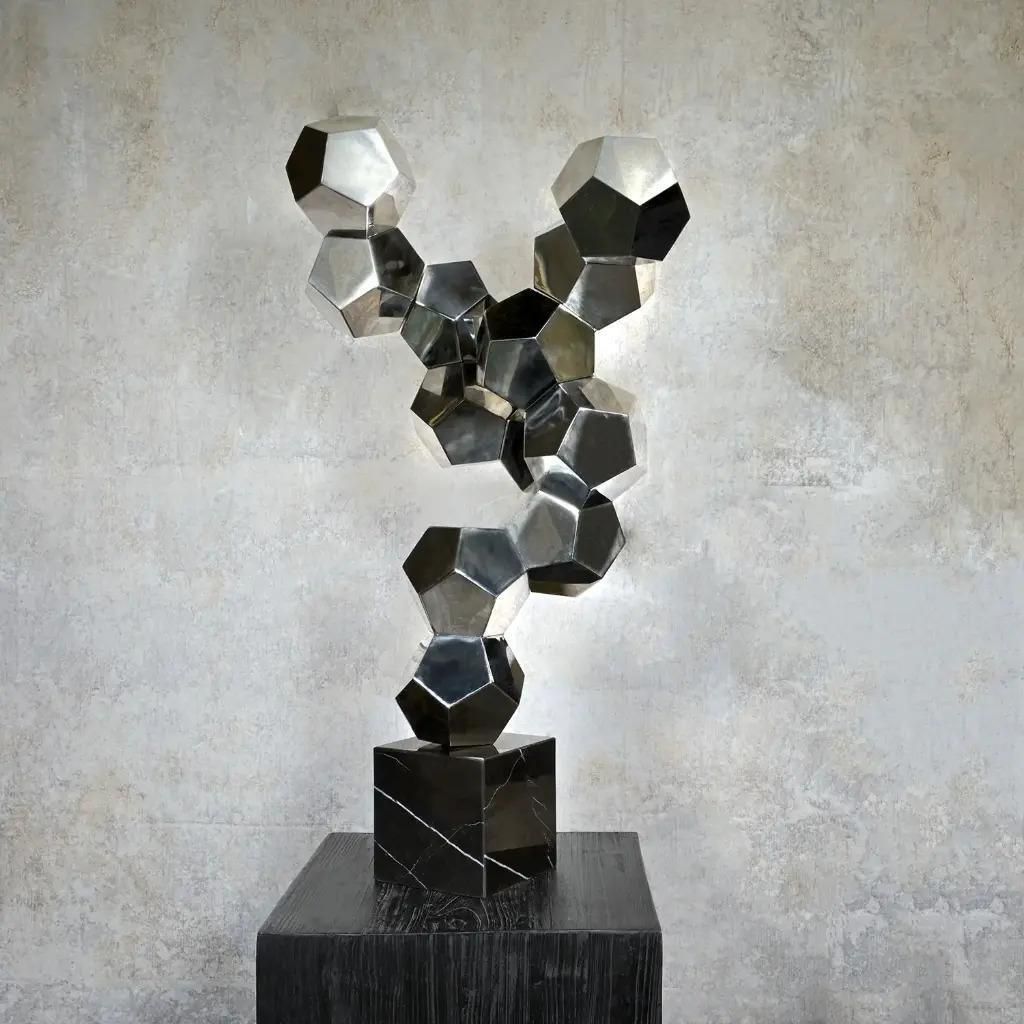 Contemporary Sculpture In Chromed Metal On A Black Marble Base photo furniture