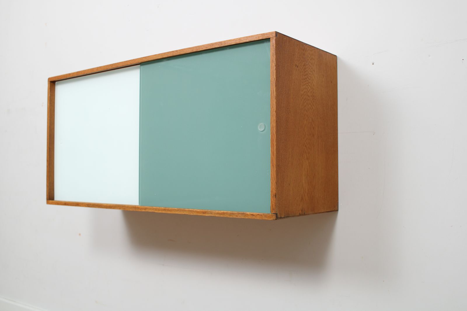 A Vintage Mid Century Wall Hung Bookcase/Cabinet With Glass Sliding Doors photo for sale