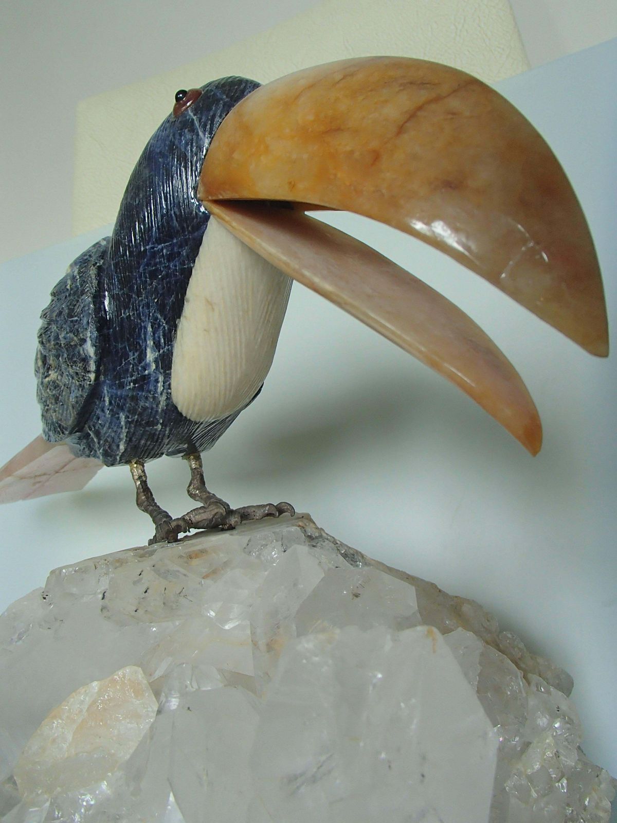 Tucan Sitting On A Cristall Made Of Sodalith And Rose Quarz photo vintage