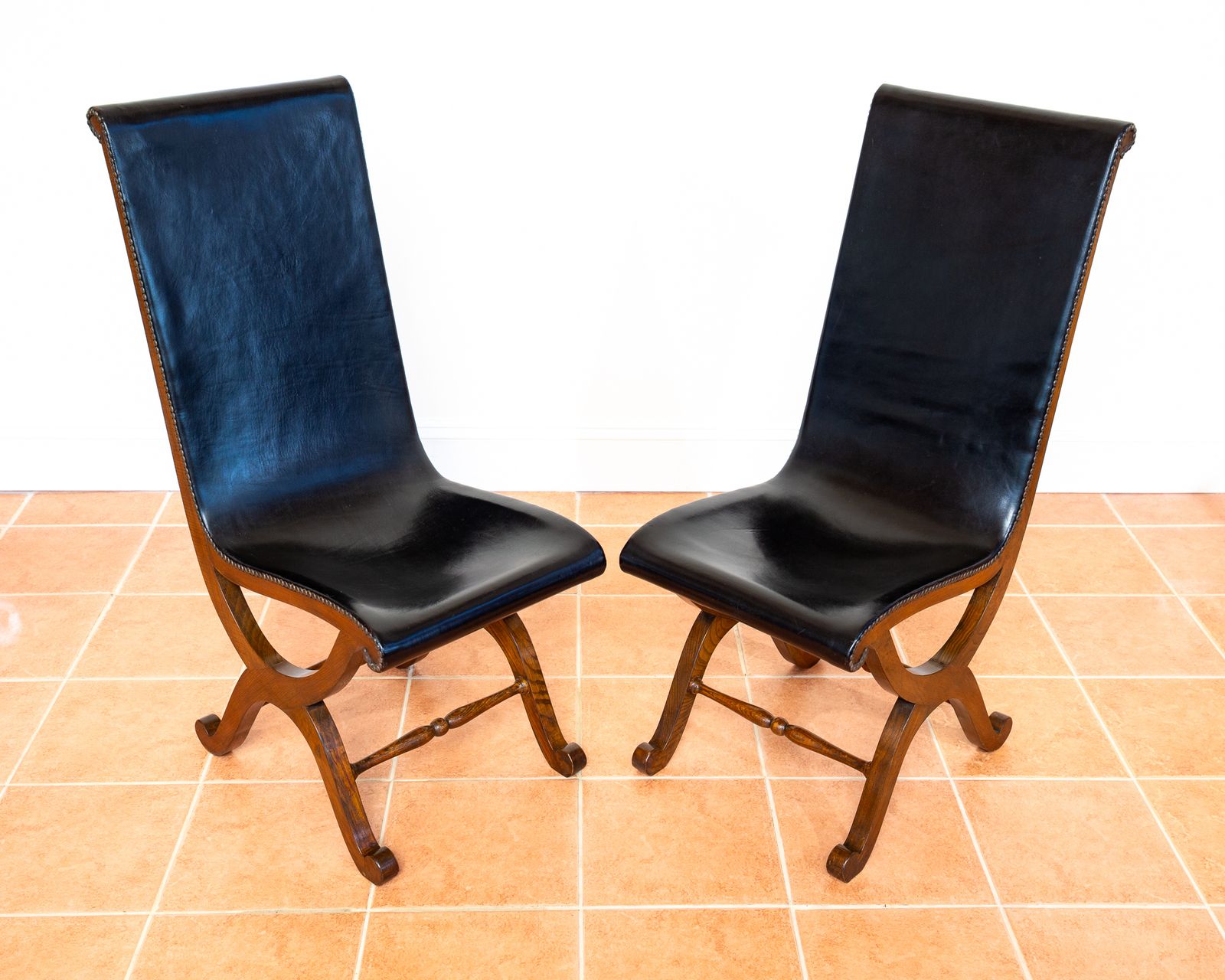 photo for sale Pair Of Spanish Oak Leather Dining Chairs By Pierre Lottier Valmazan Mid Century Neoclassical Colonial 1960s Black Leather Sling Seat Studded Leather