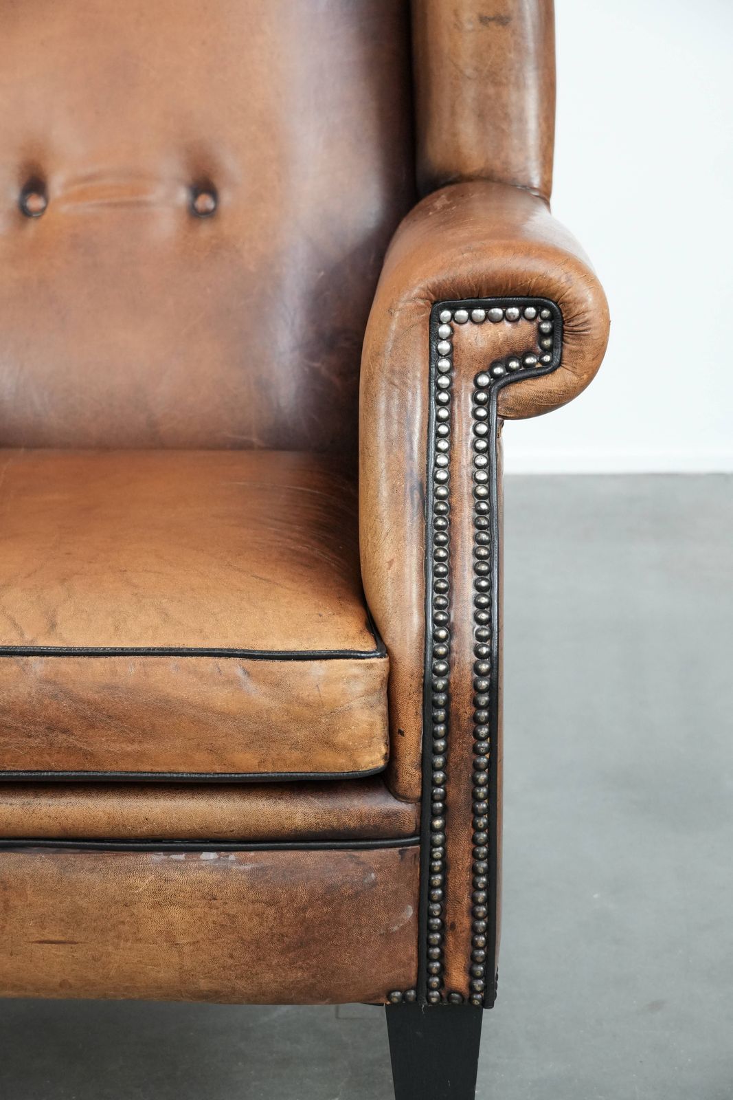 photo for sale Large And Comfortable Sheepskin Wing Chair With A Characterful Look With Black Piping And Decorative Studs