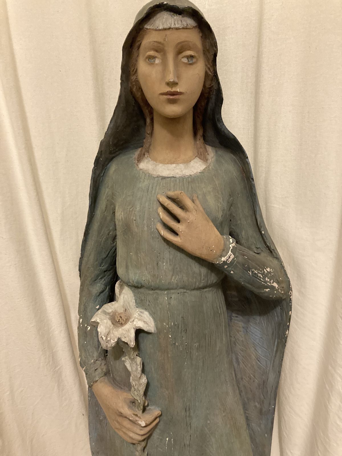 Antique Statue Of The Young Virgin Mary Holding A Lily. photo furniture