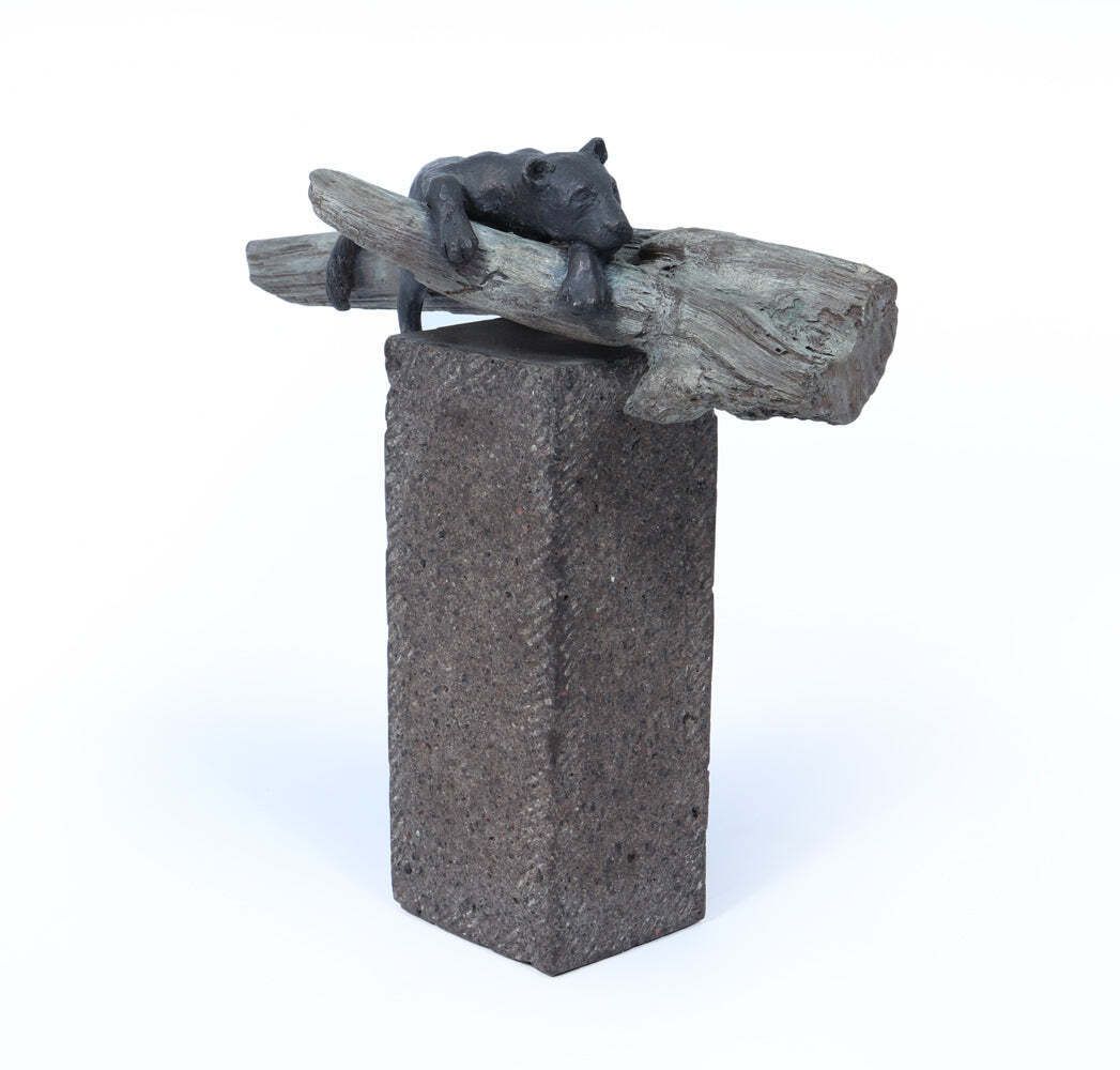 photo furniture Bronze Sculpture Of A Resting Lioness On Cold Painted Log