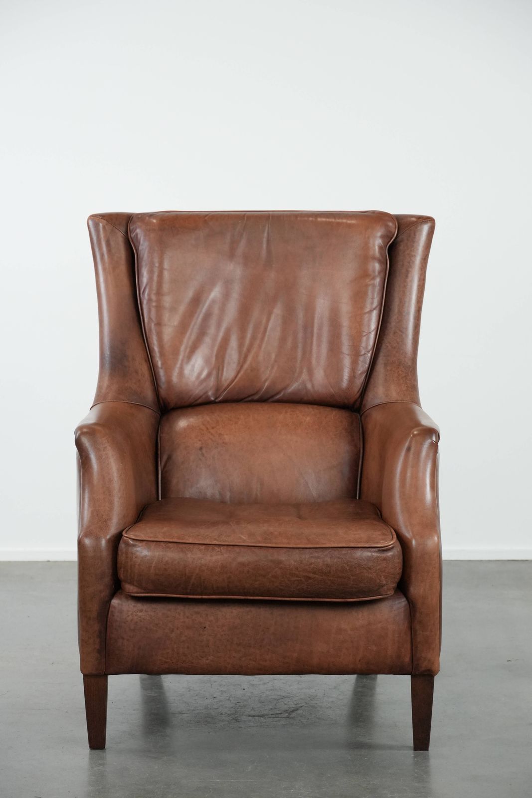 Very Comfortable And Luxurious Cognac Brown Cowhide Armchair With A Decorative Stud Finish photo furniture