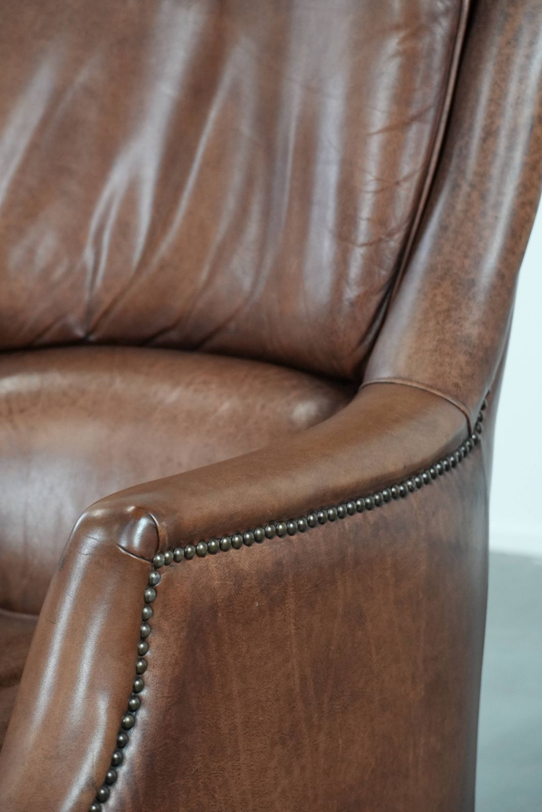 photo buy Very Comfortable And Luxurious Cognac Brown Cowhide Armchair With A Decorative Stud Finish