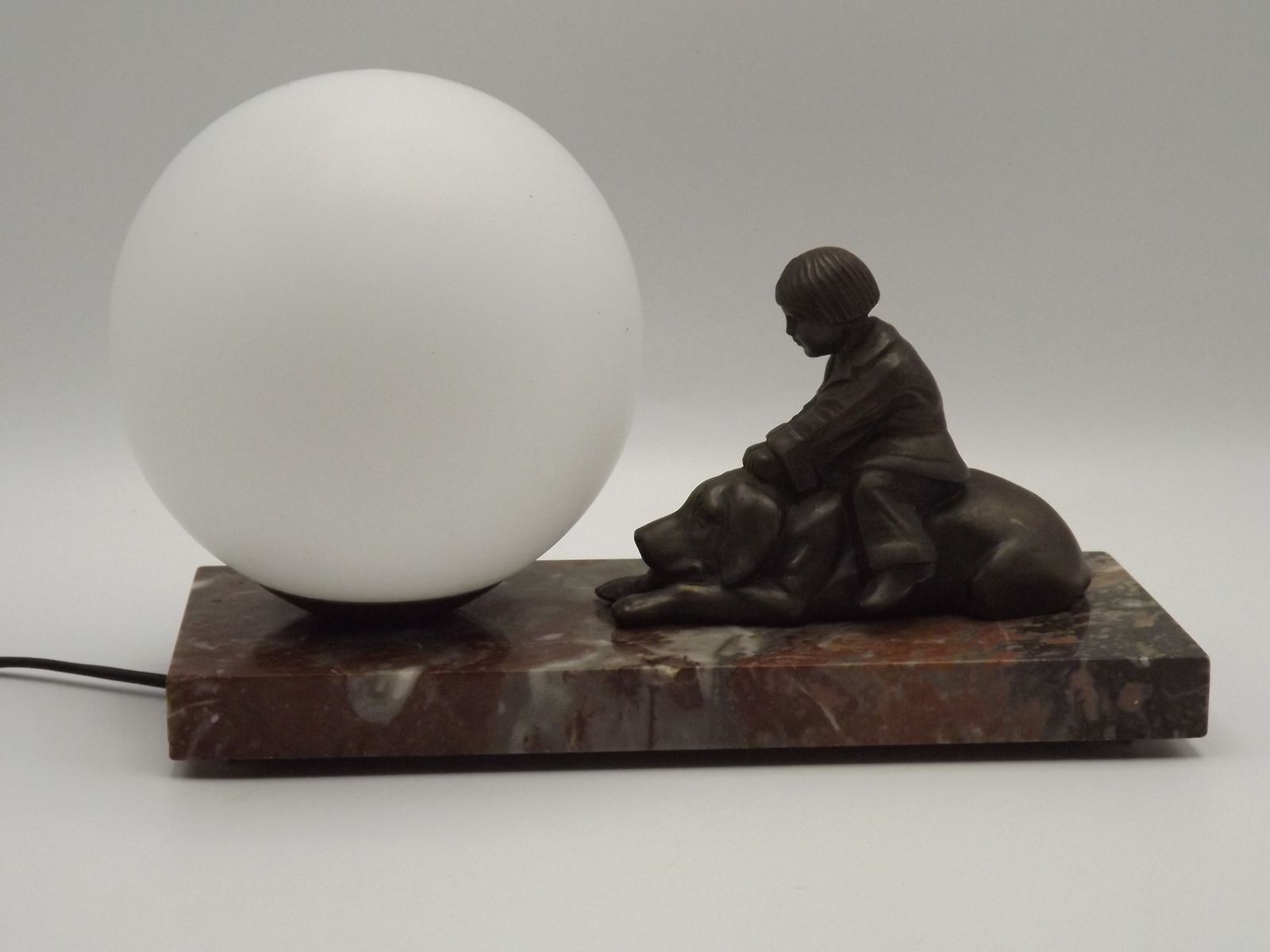 photo vinterior French Art Deco Table Lamp With Brown Marble Base Dog & Child Figure And White Opaline Glass Ball Shade