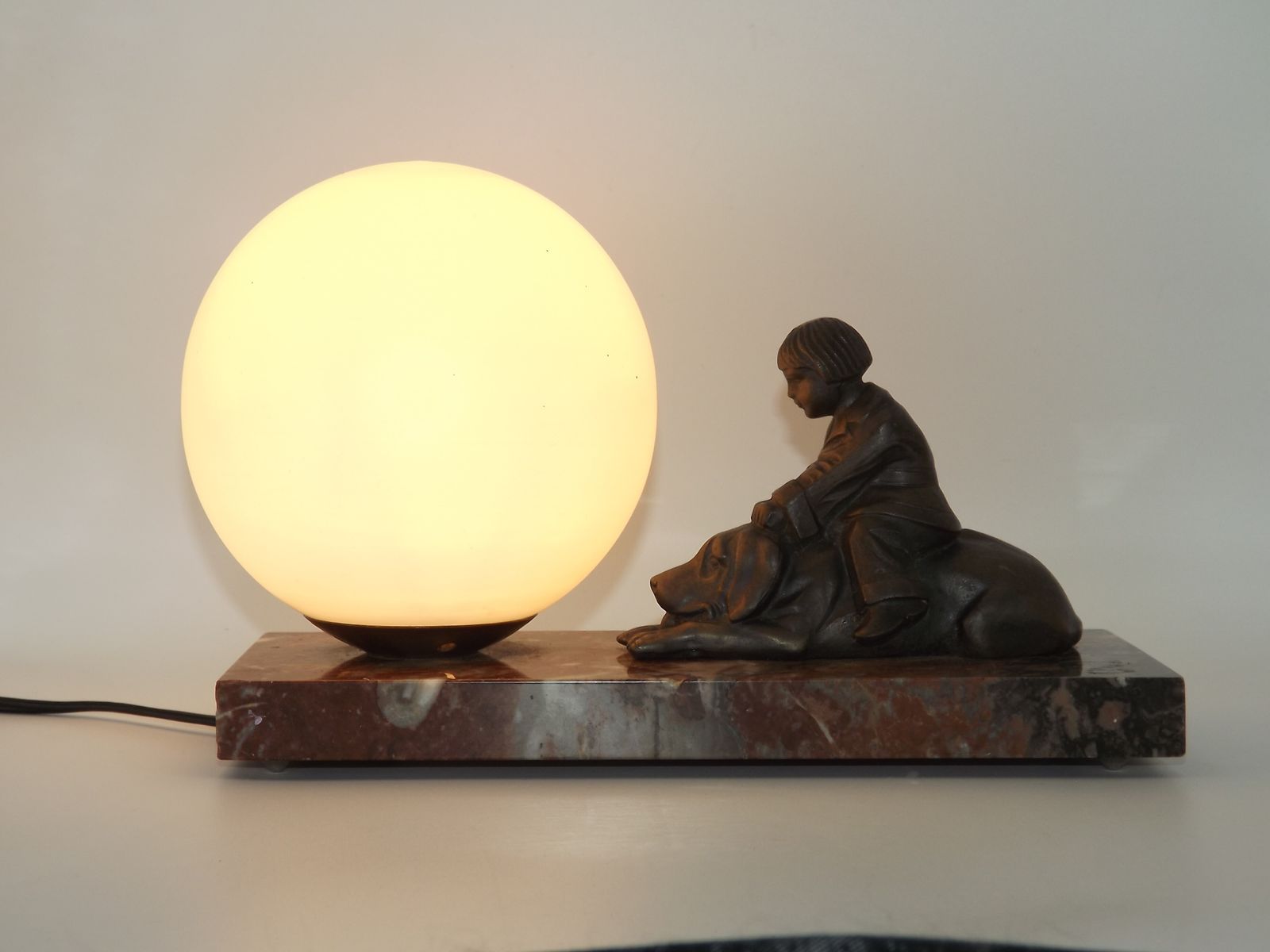 French Art Deco Table Lamp With Brown Marble Base Dog & Child Figure And White Opaline Glass Ball Shade photo for sale