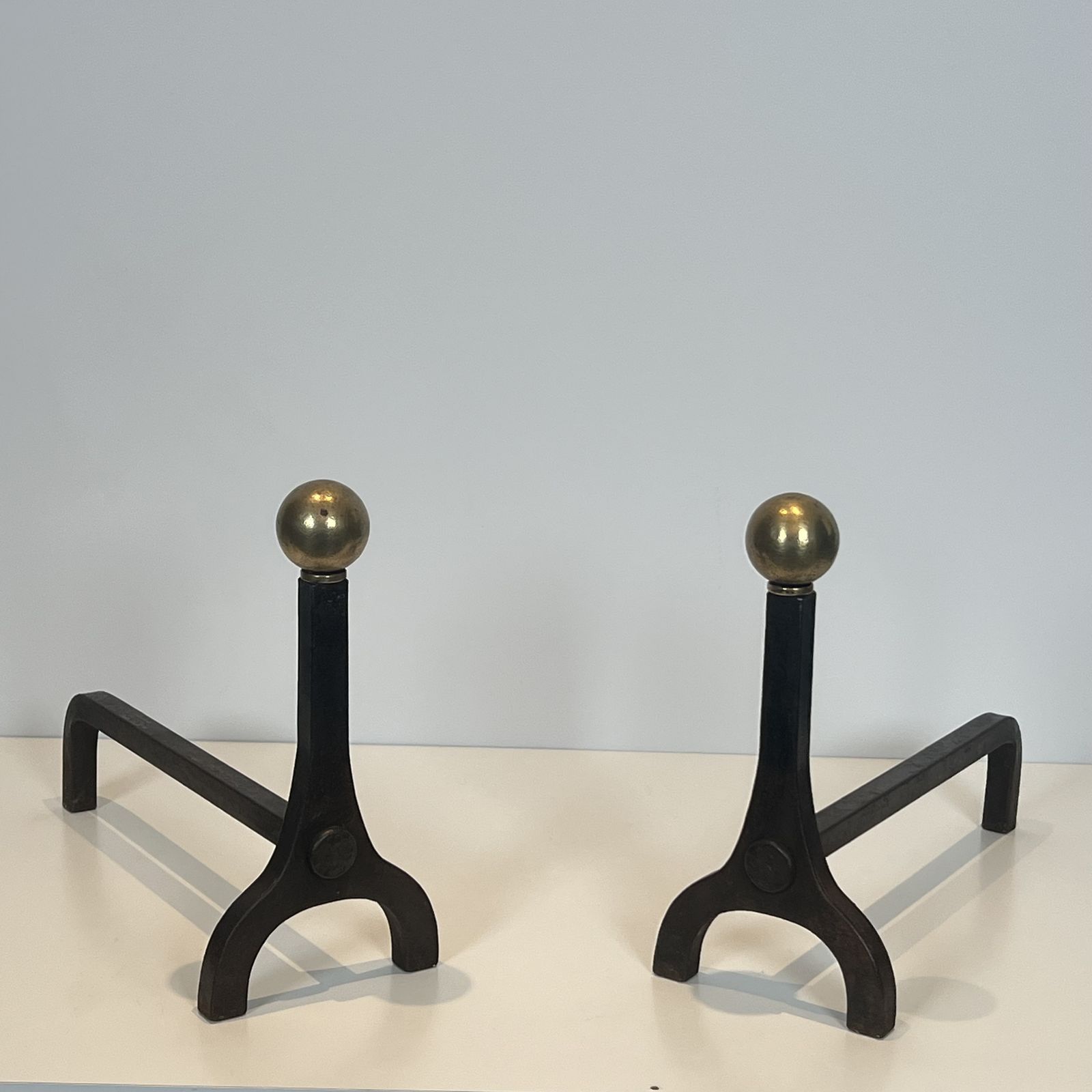 Pair Of Modernist Andirons In Steel, Wrought Iron And Brass By Jacques Adnet