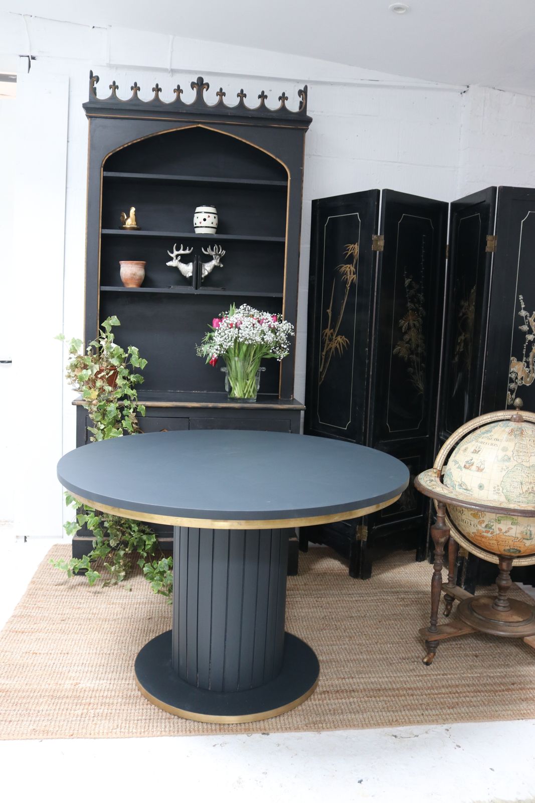Stunning Black Round Dining Table With Brass Metal Edge Slatted Wood Column Base photo for sale