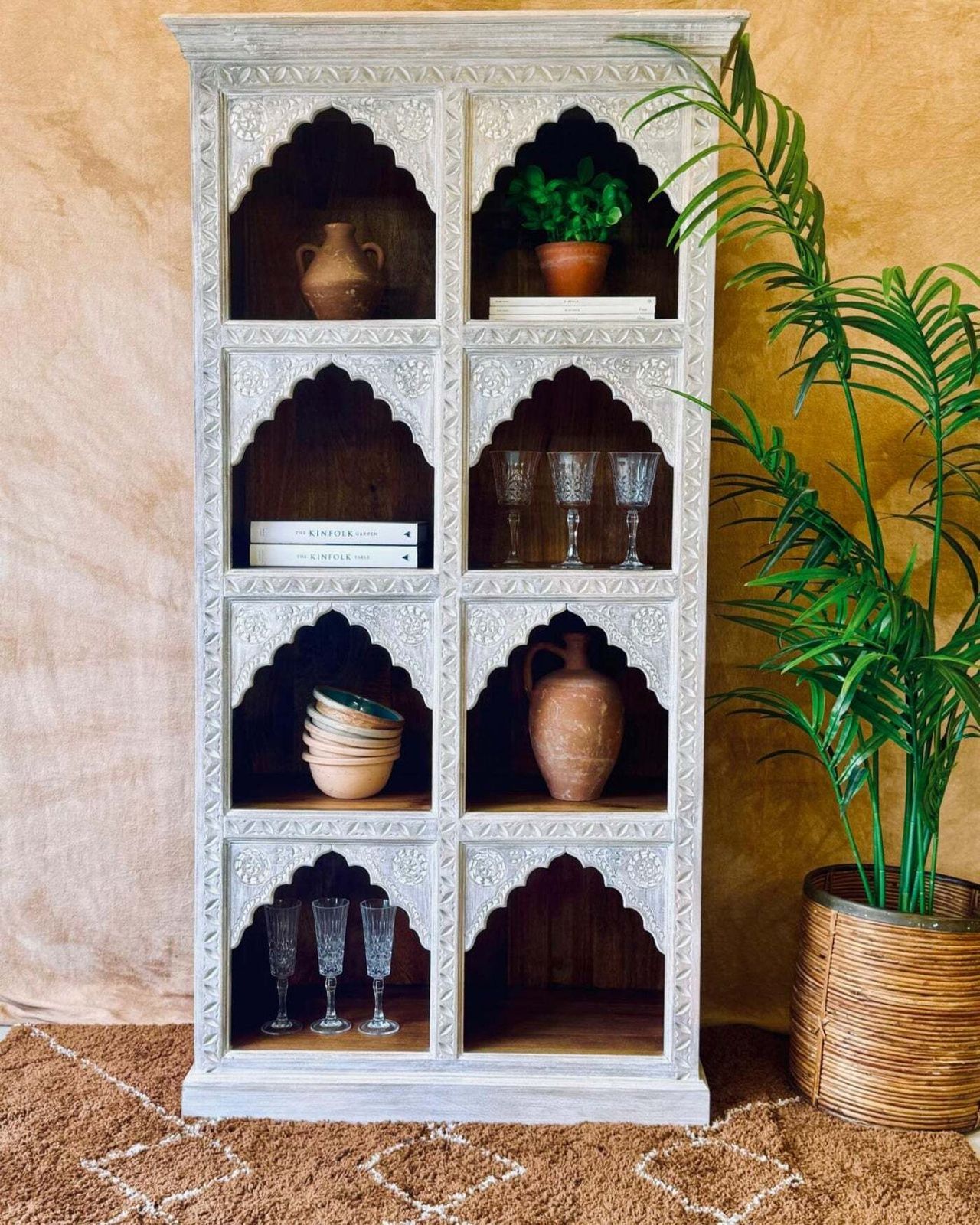 photo furniture Hand Carved Mango Wood Bookcase With A Light Natural Cream Washed Finish And Arched Shelves
