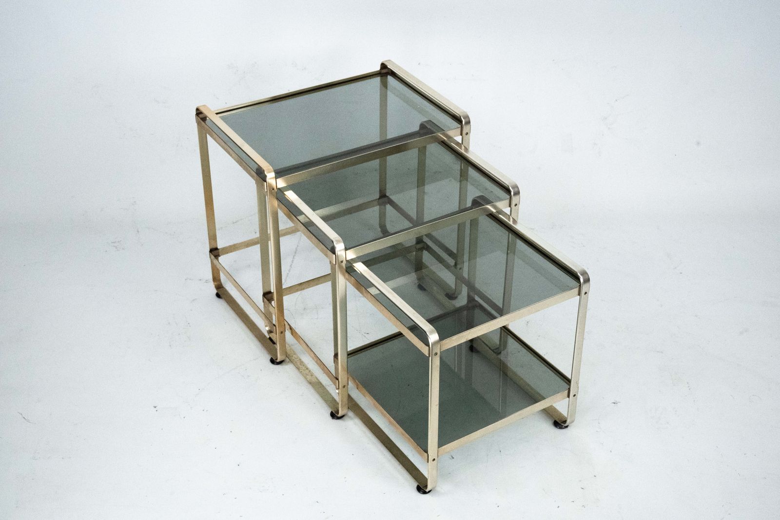 Set Of Three Nesting Side Tables In Gilded Aluminum And Glass – Italy, 1970s