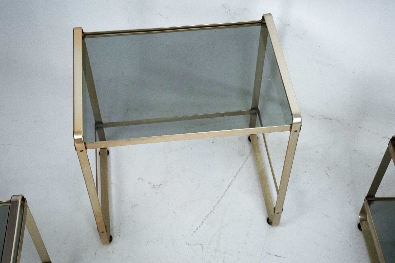 photo furniture Set Of Three Nesting Side Tables In Gilded Aluminum And Glass – Italy, 1970s
