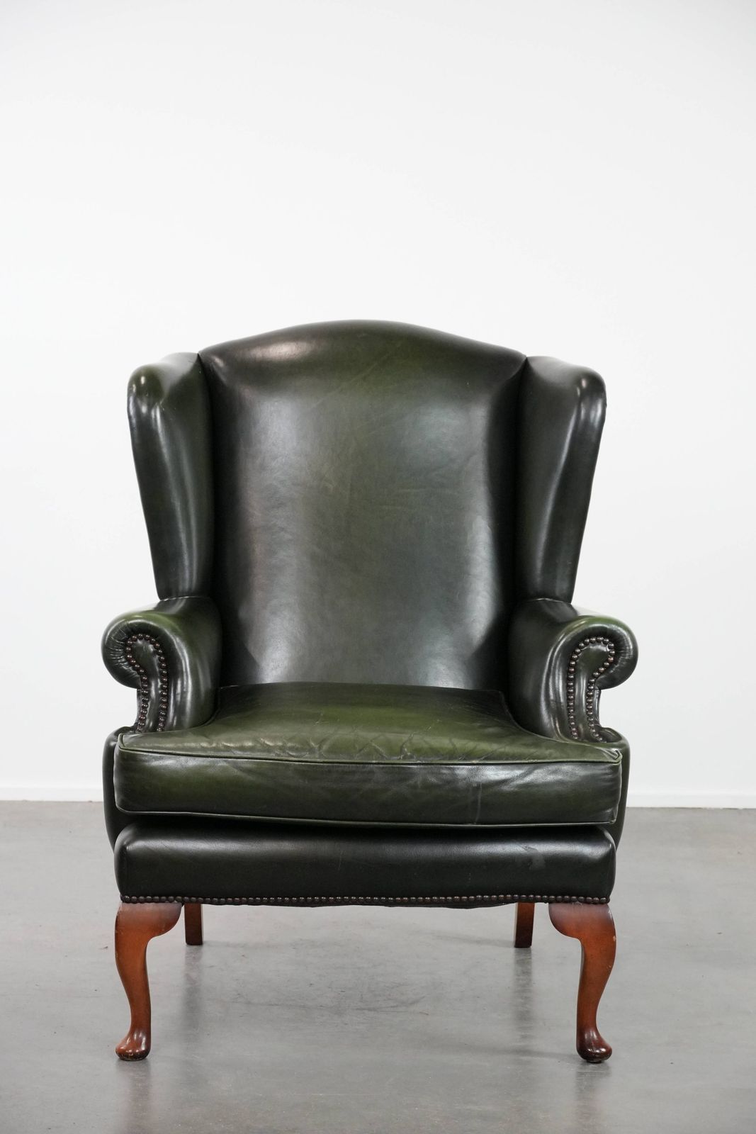 Beautiful Smooth Classic Cowhide Chesterfield Wing Chair In A Stylish Dark Green Color photo furniture