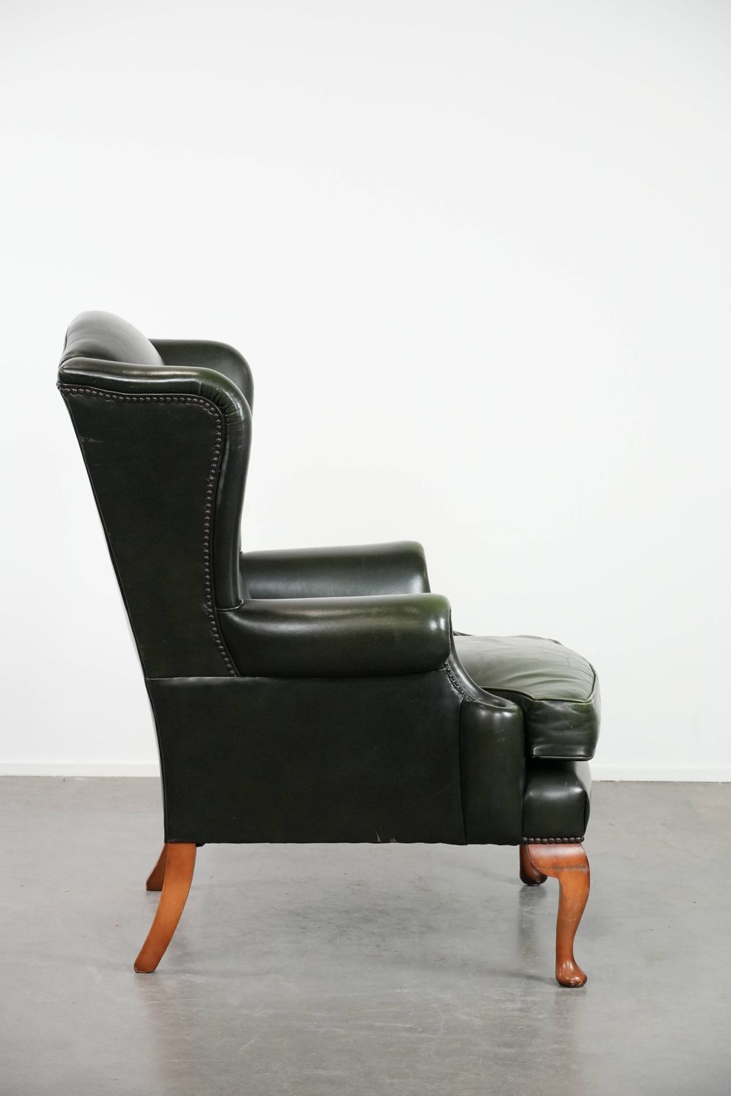 Beautiful Smooth Classic Cowhide Chesterfield Wing Chair In A Stylish Dark Green Color photo for sale