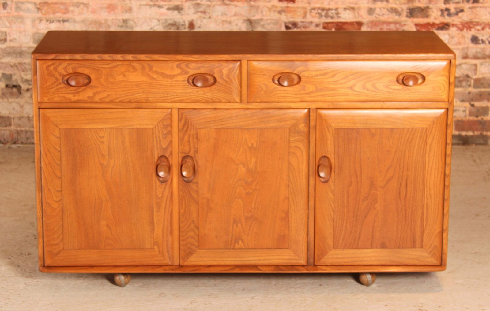 Mid Century Ercol Windsor Solid Elm Sideboard On Casters, Circa 1960s photo furniture