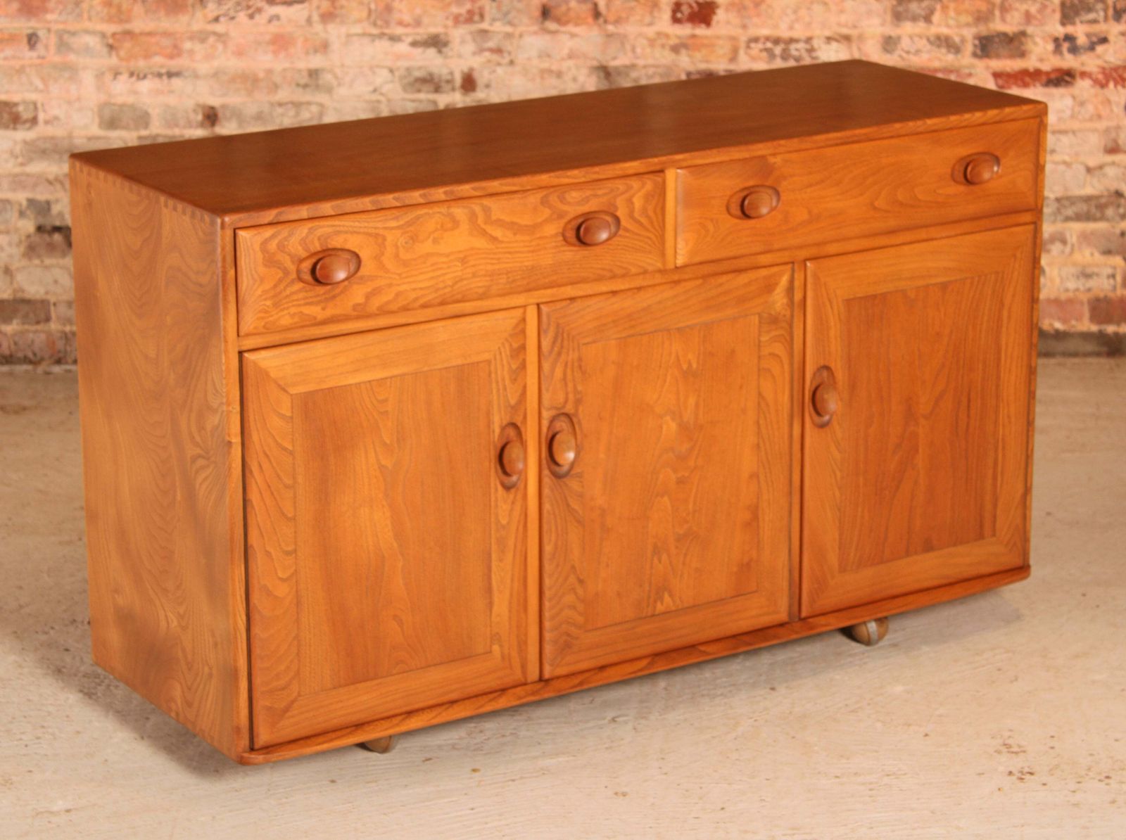 Mid Century Ercol Windsor Solid Elm Sideboard On Casters, Circa 1960s photo for sale