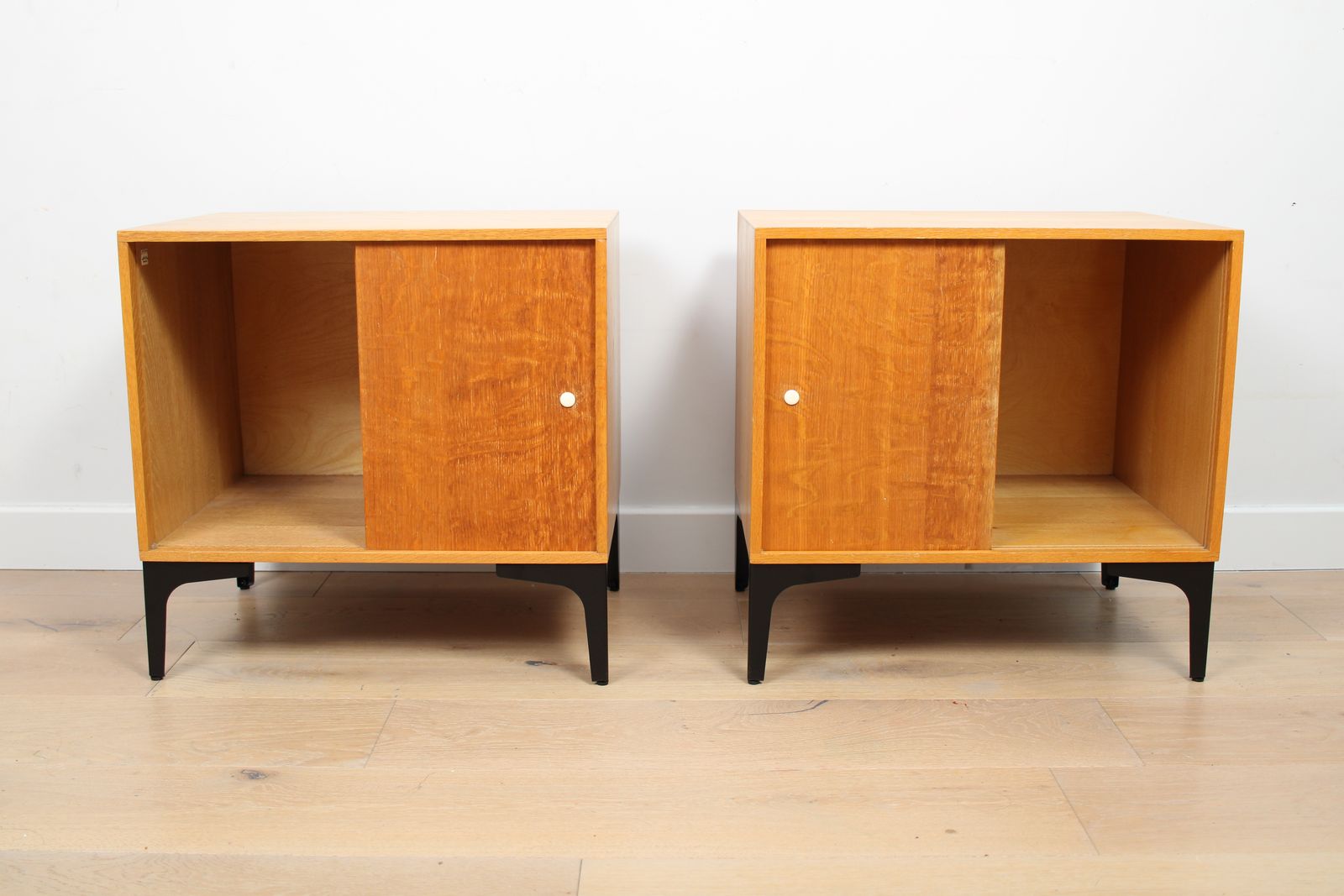 A Pair Of Vintage Mid Century Bedside Tables With Oak Sliding Doors photo vintage
