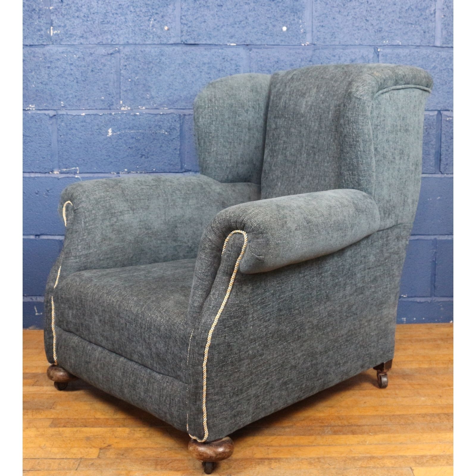 A Large Victorian Freshly Reupholstered Open Wing Arm Chair Raised On Bun Feet