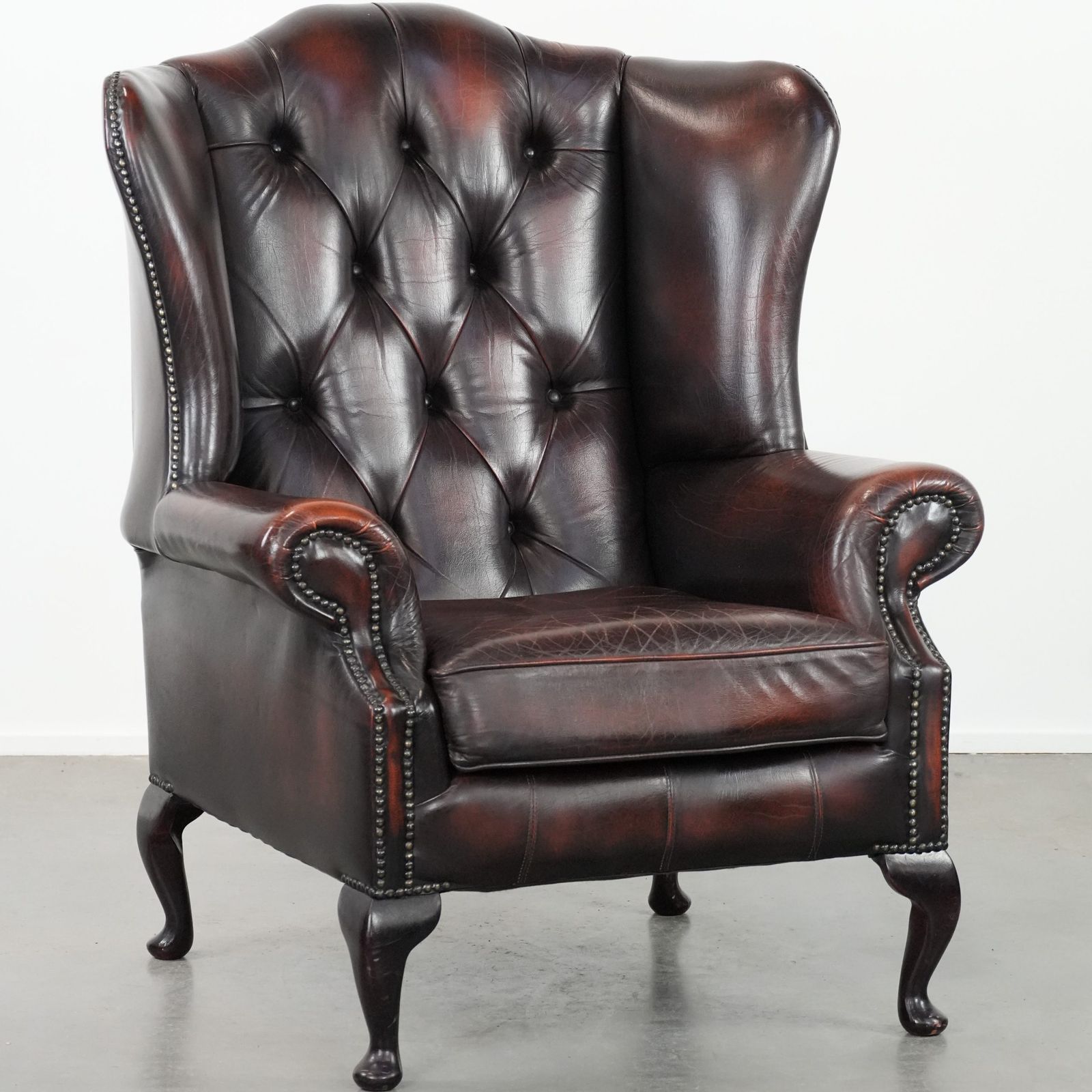 Beautiful, Luxurious, And Comfortable Brown Cowhide Chesterfield Wing Armchair In A Classic English Style.