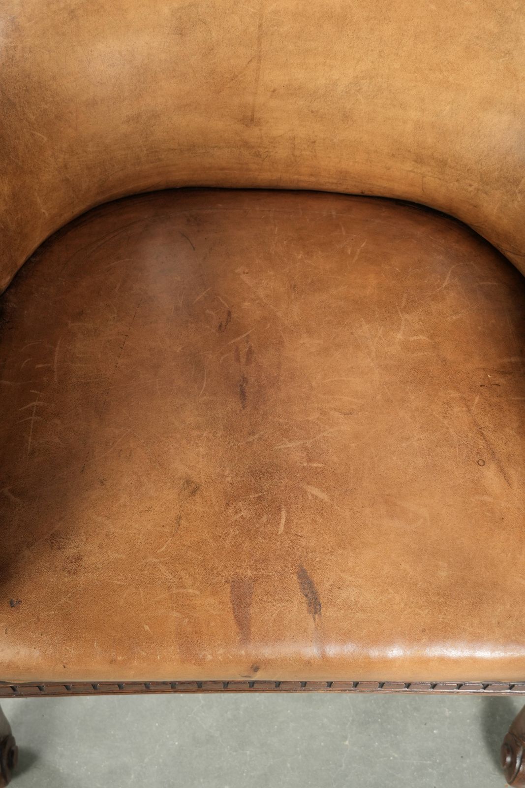 Antique Armchair Of Sheepskin And Wood With Decorative Nails And Beautiful Woodwork photo vinterior