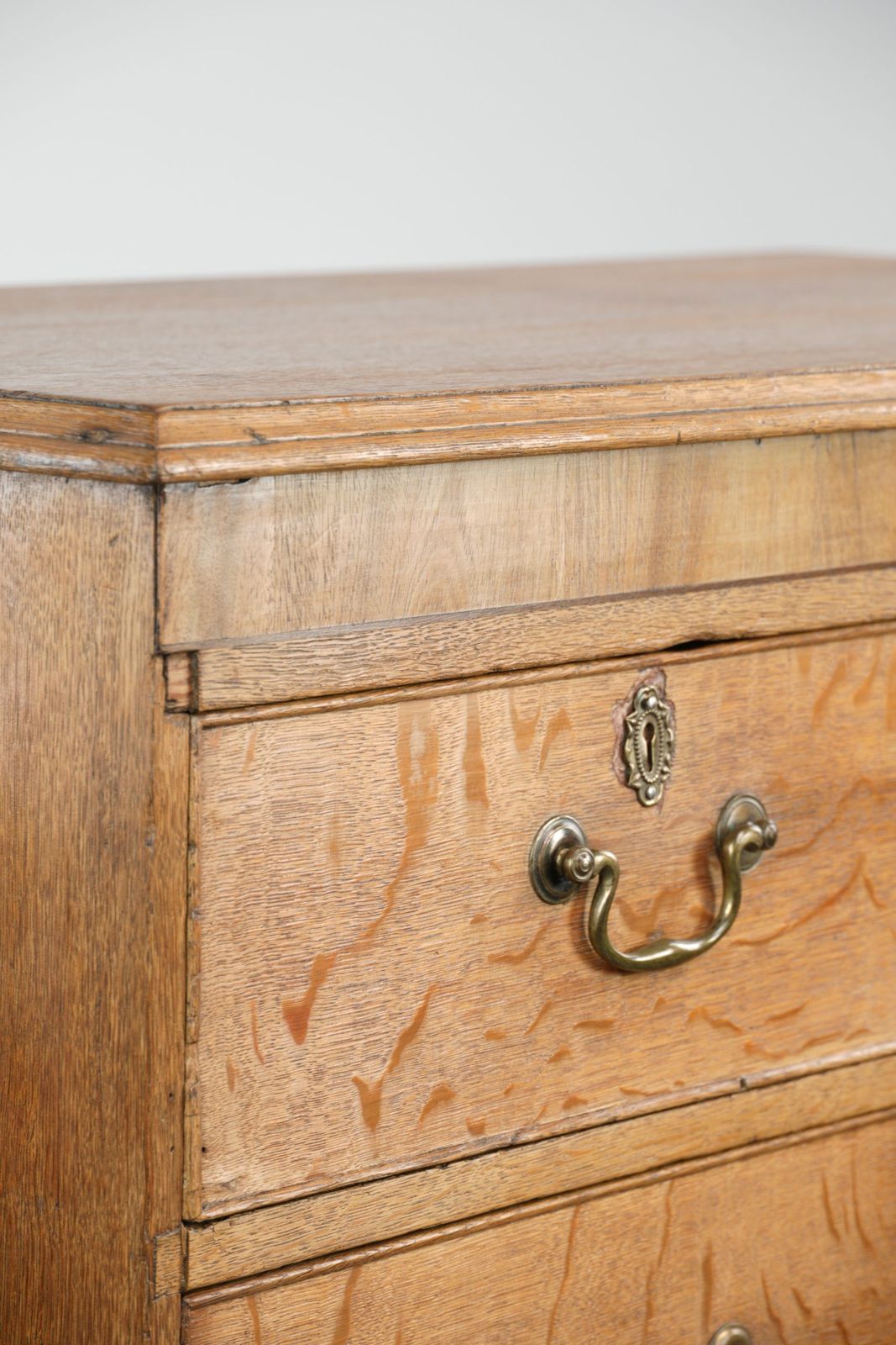 photo for sale Large Antique English Blonde Oak Chest Of Drawers From The 18th Century With Gold Colored Elements
