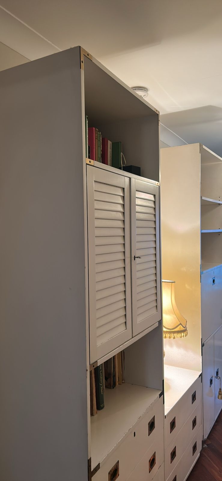 A Mid Century Modular White Shelving Unit In A Campaign Style With Solid Brass Features photo for sale