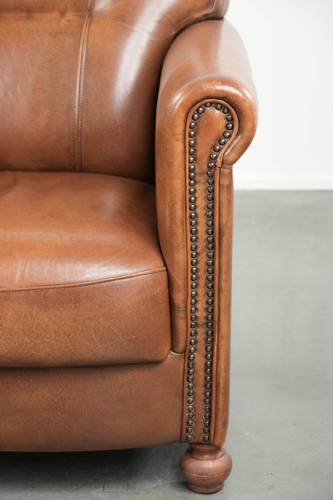 photo furniture Beautiful, Stately Armchair In Good Condition, Made Of Sheepskin With A Refined Finish Featuring Decorative Nails.