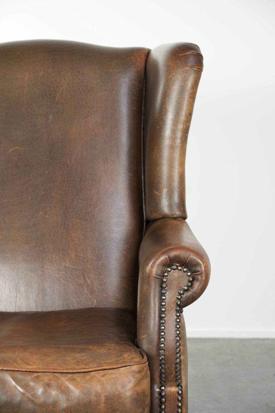 photo furniture Large, Characterful Sheepskin Wing Armchair With Beautiful Warm Colors And A Stunning English Style Patina.