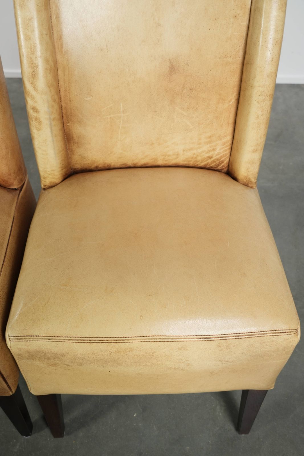 photo furniture Luxury Set Of Four Cowhide Leather Dining Chairs With A Beautiful Light Color, Comfortable Seat, And A High Back