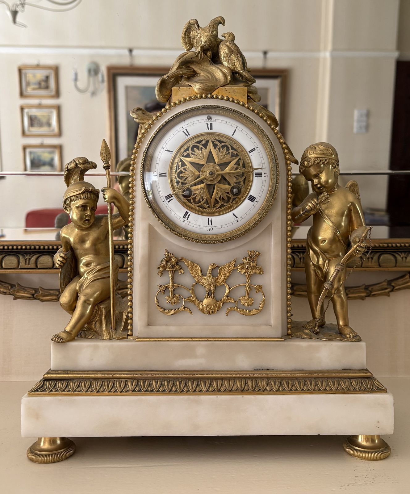Early 19th Century French Clock, Predominantly Of White Marble Mounted With Superb Ormolu Embellishments And Flanked By A Pair Of Ormolu 'Putti' In War Like Mode.