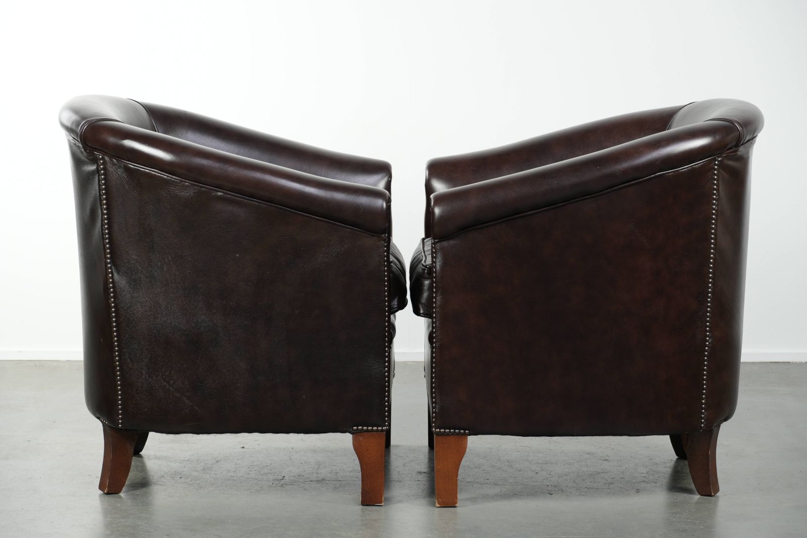 Set Van Twee Donkere Koeienhuid Club Fauteuils In Goede Staat Met Een Tijdloos Engelse Stijl Design photo furniture