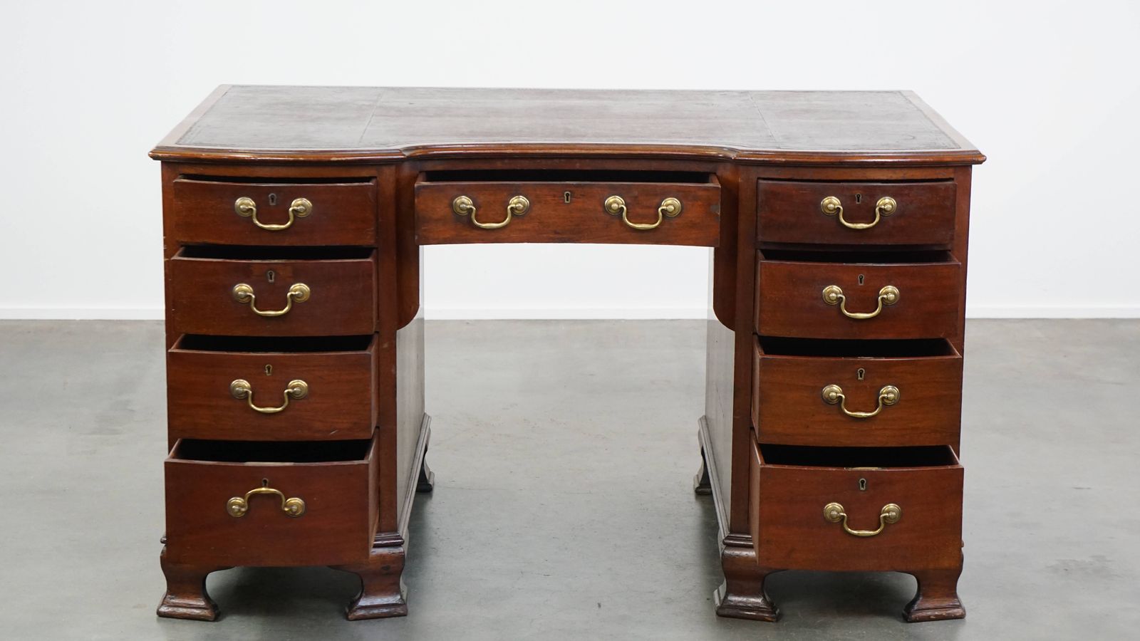 Antiek Engels Houten Bureau Uit De Eind 19e Eeuw Met Lederen Blad En Gebogen Front. photo for sale