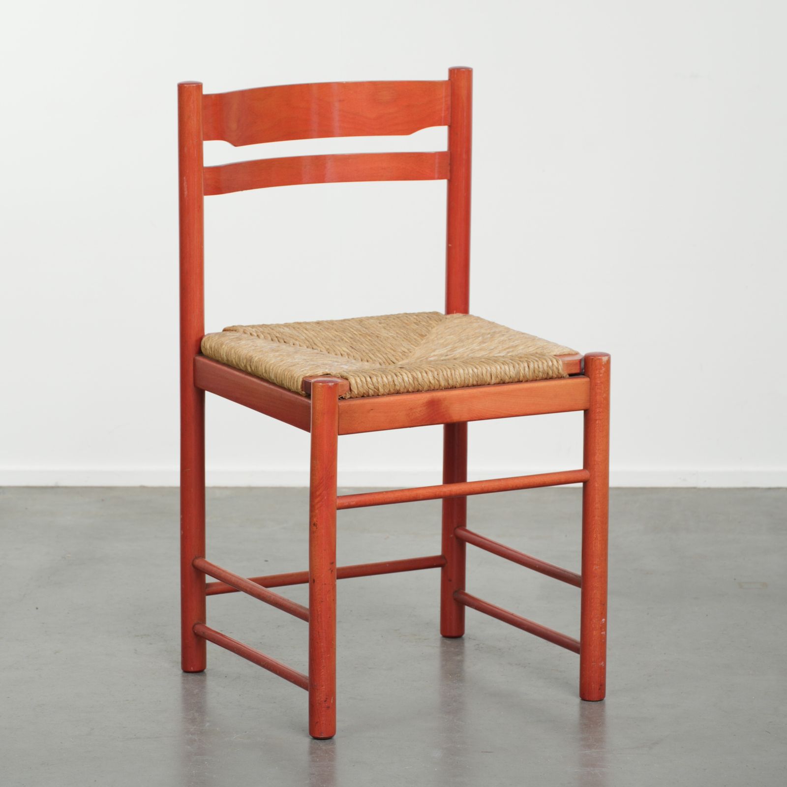 Cute Red Vintage Wooden Chair From The 70’s With A Braided Wicker Seat