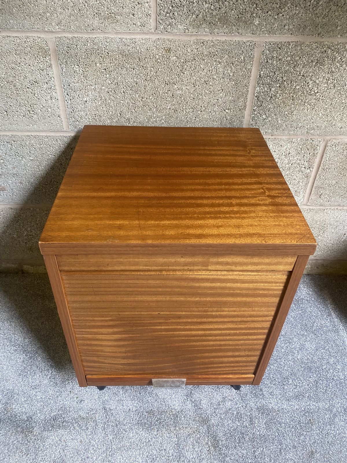 A Charming Vintage Mid Century Record Cabinet With A Tambour Front, Warm Wood Grain And Smart Tapered Legs. photo for sale