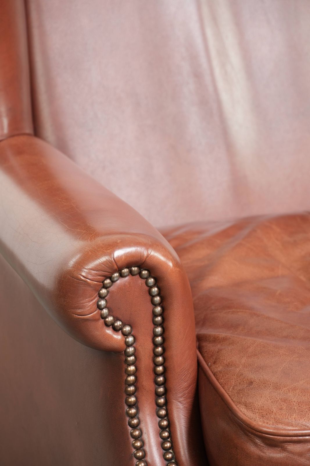 photo for sale Comfortable Cognac Colored Cowhide Leather Wing Armchair In English Style With A Warm Appearance
