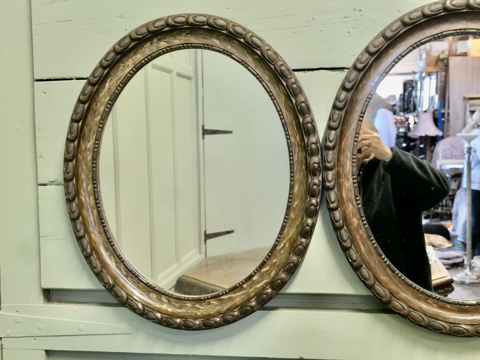 A Pair Of Simulated Wood Finish Oval Mirrors These Mirrors Have Very Attractive Wide Moul photo for sale
