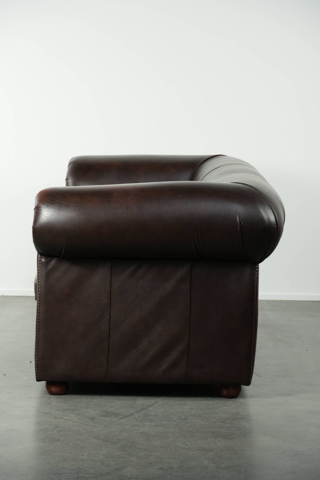 Luxueuze bruine gladde rundleren Chesterfield-bank met een tijdloze Engelse uitstraling. photo Meubels