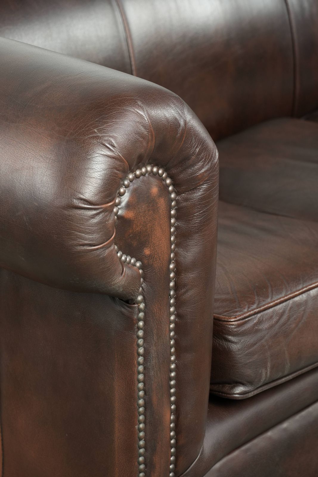 photo buy Luxueuze bruine gladde rundleren Chesterfield-bank met een tijdloze Engelse uitstraling.