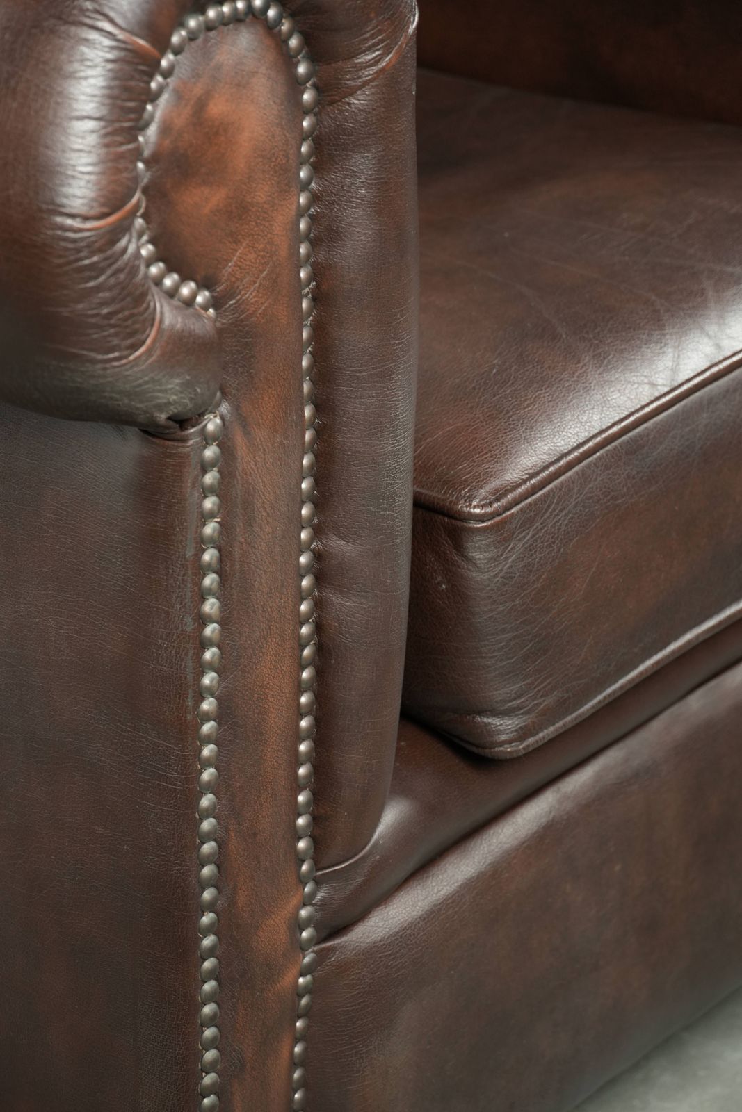 photo for sale Luxurious Brown Cowhide Chesterfield Armchair With A Timeless English Look.